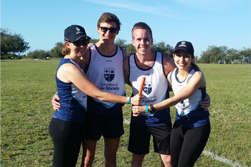 small group of persons standing on sport field