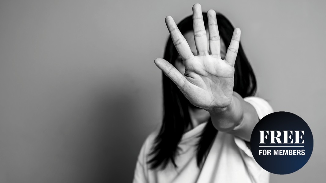 A picture of a woman holding her hand up outstretched to stop something