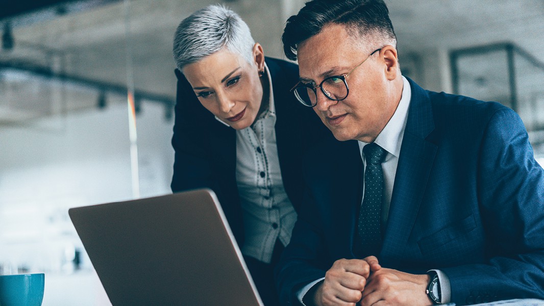 Picture of a man and woman looking at a laptop