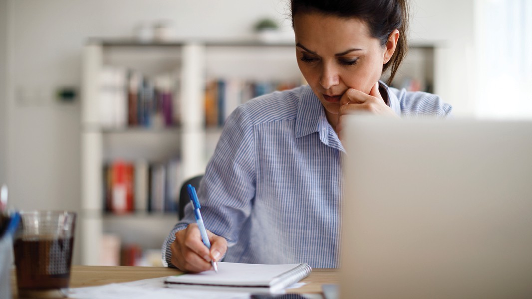Picture of a woman writing on a notepad