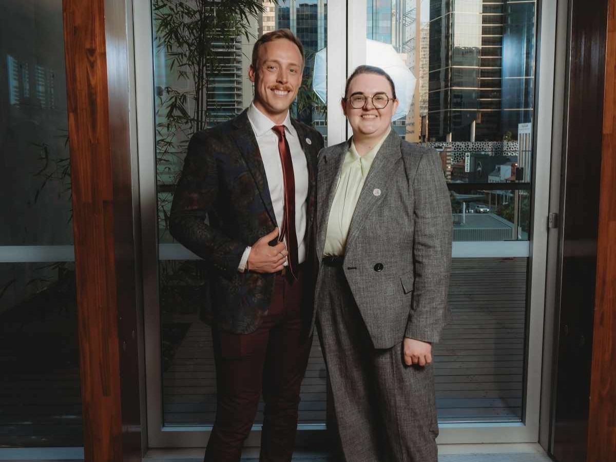 Duncan and Louis standing together in a corporate environment