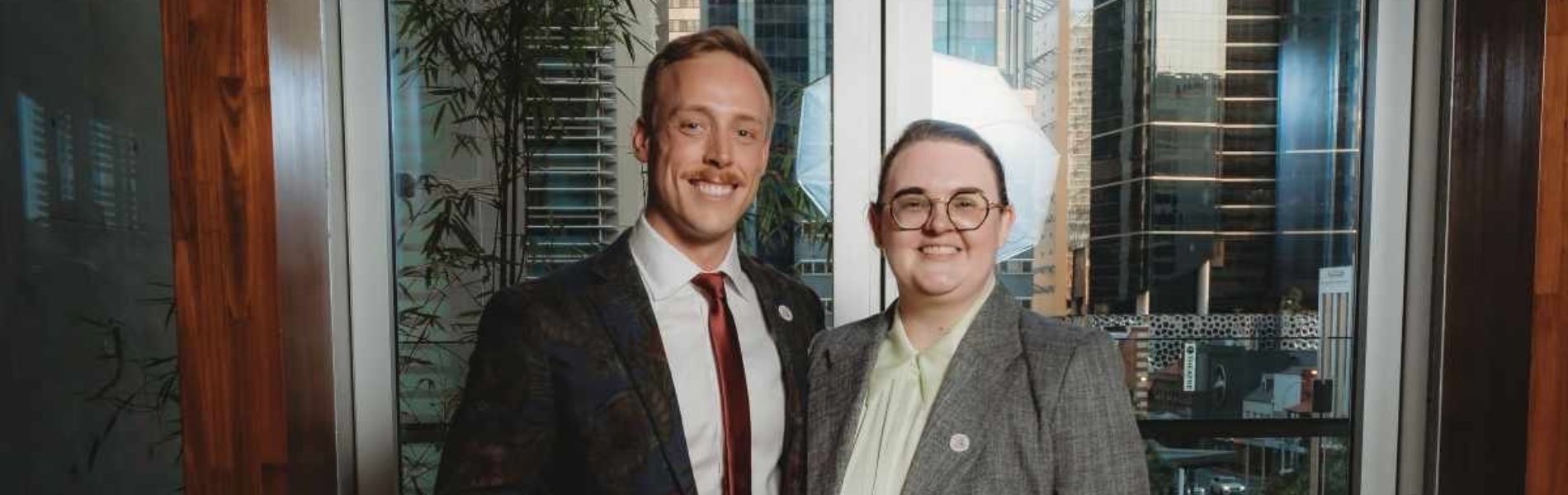 Duncan and Louis standing together in a corporate environment