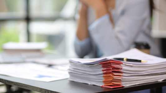 Stack of papers with a pen