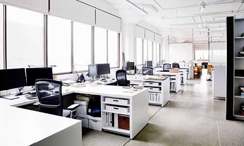 rows of white desks in office