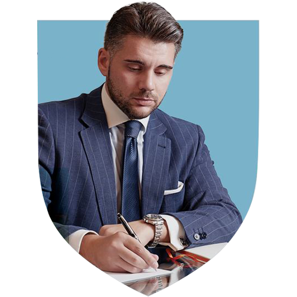 Man in a suit writing on a document
